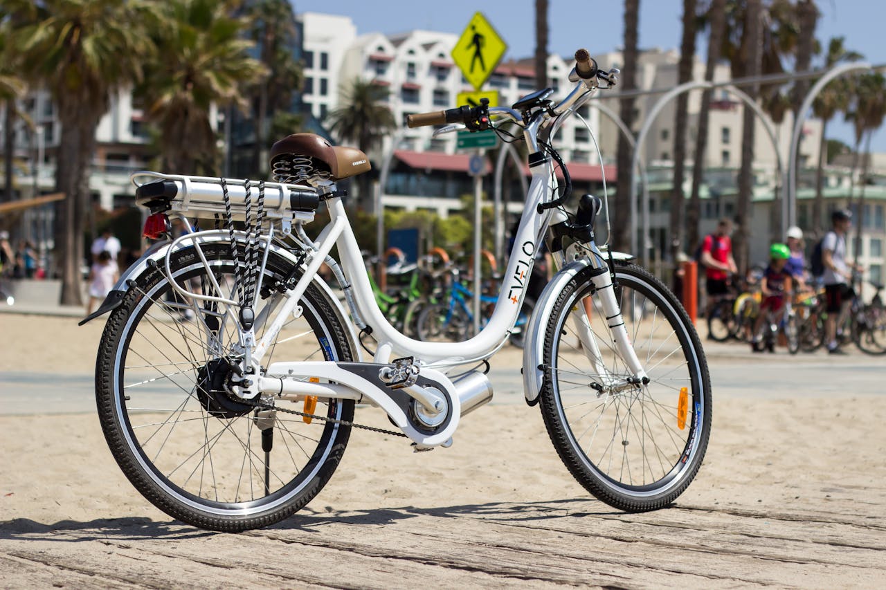 Electric bike parked on a sunny beach in Los Angeles, perfect for city exploration.